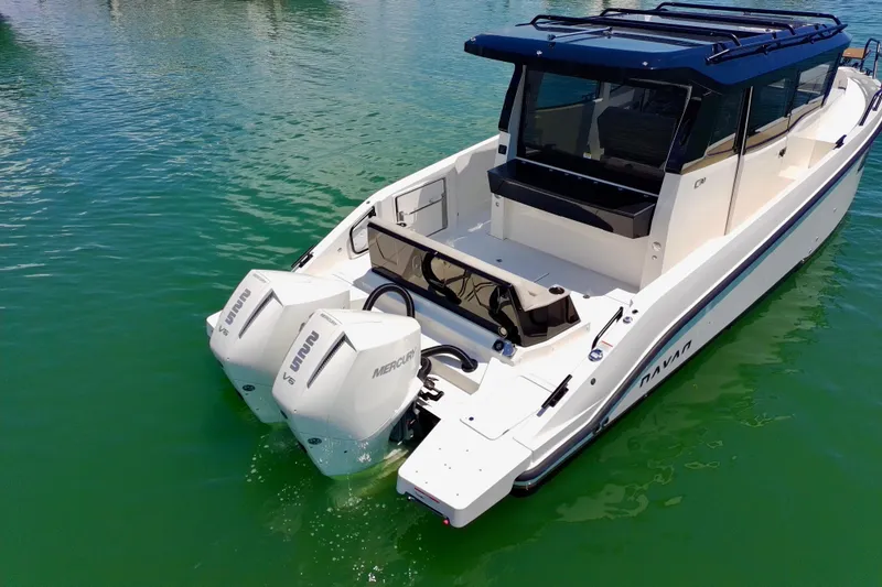 Slide: The Image of 2026 Navan C30 boat with dual Mercury engines on calm water. - 8
