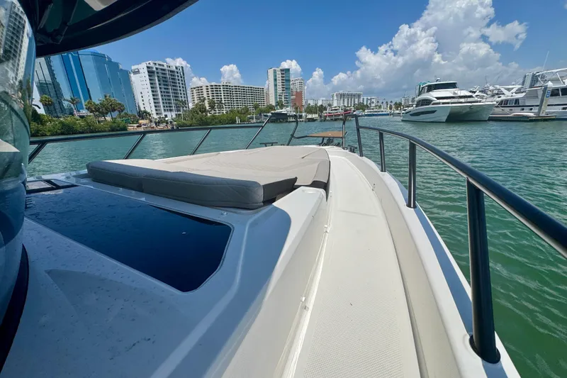 Slide: The Image of Luxurious 2026 Navan C30 yacht docked in a scenic marina with city skyline. - 50