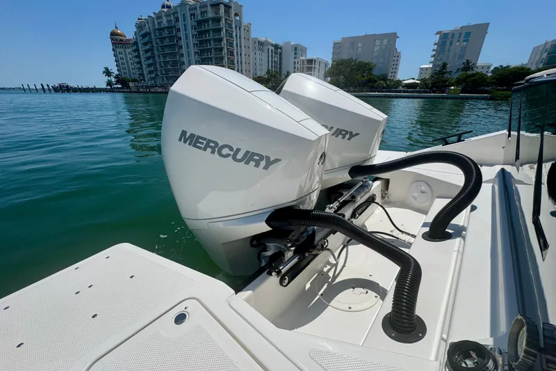 Slide: The Image of Navan C30 2026 boat with dual Mercury outboard engines, docked near waterfront buildings. - 11