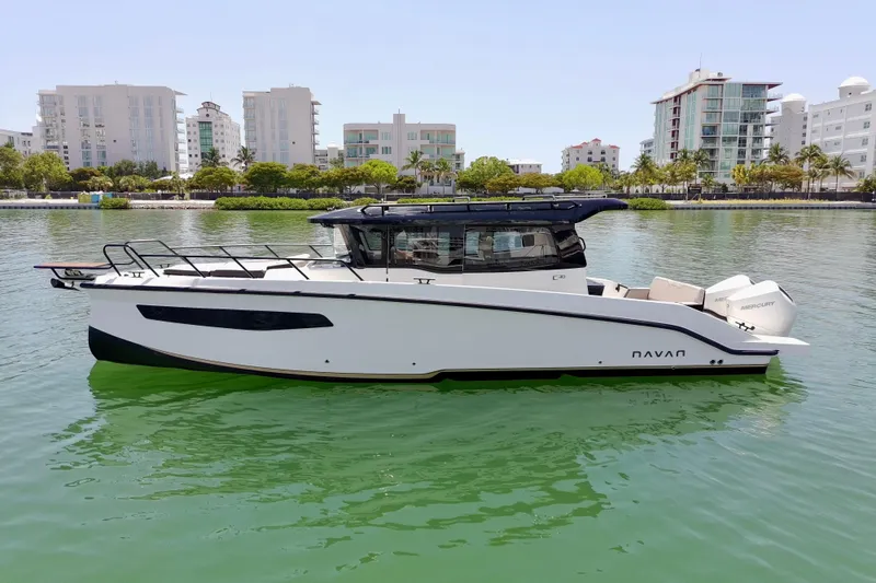 The Image of 2026 Navan C30 boat on calm water with cityscape background. - 0