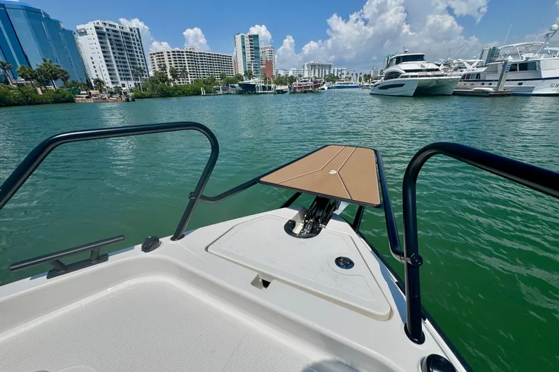 Slide: The Image of Bow view of 2026 Navan C30 boat in a marina with city skyline. - 53