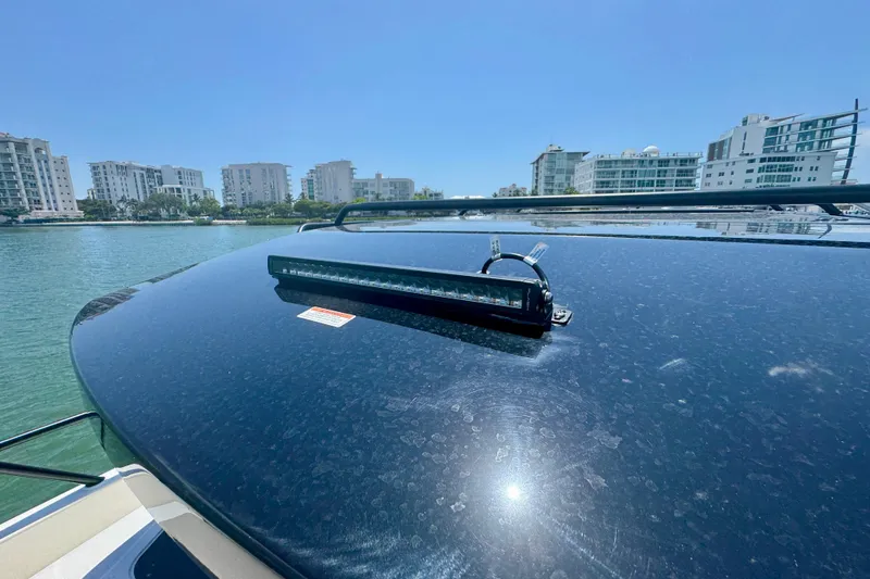 Slide: The Image of Rooftop view of 2026 Navan C30 boat with light bar, cityscape in background. - 55