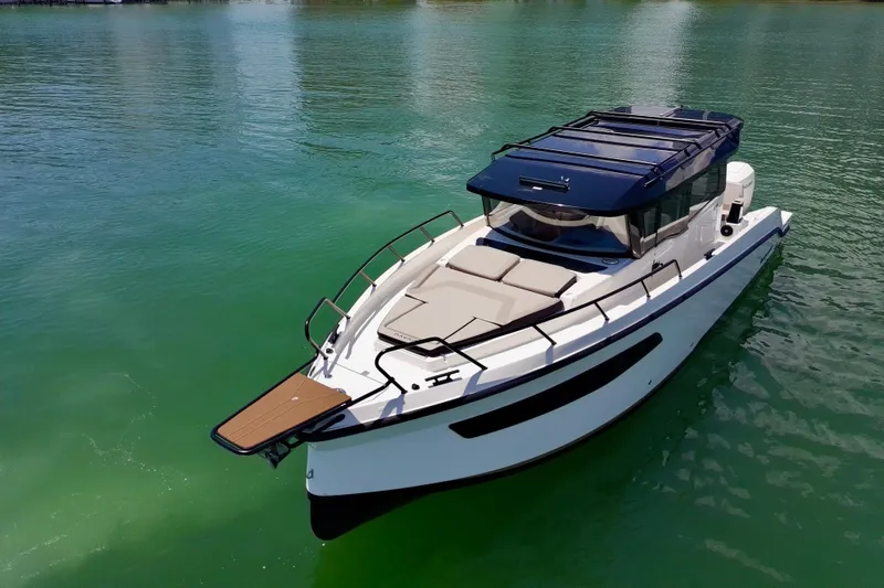 Slide: The Image of Modern 2026 Navan C30 boat on calm green water, featuring sleek design and spacious deck. - 9