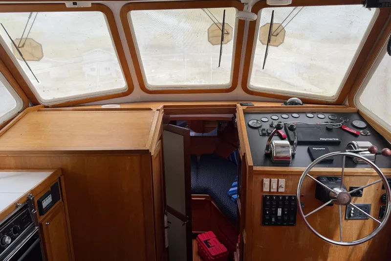 Slide: The Image of 1998 Sabreline 36 Fast Trawler helm with wooden interior and navigation controls. - 23