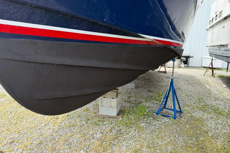 Slide: The Image of 1998 Sabreline 36 Fast Trawler on stands, showcasing hull design and vibrant stripe. - 4