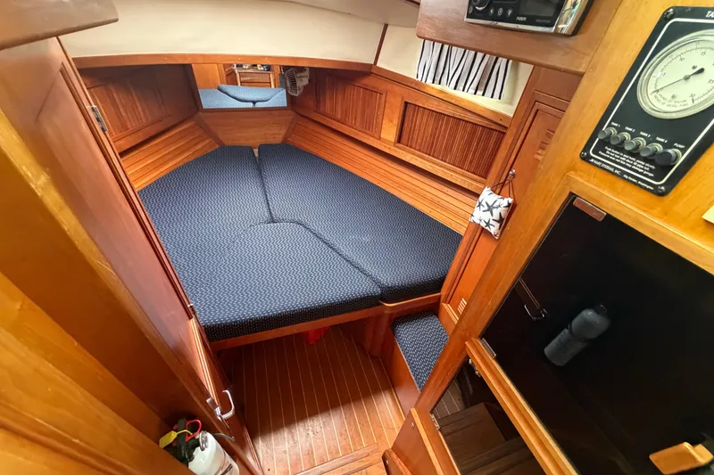 Slide: The Image of Cozy cabin interior of 1998 Sabreline 36 Fast Trawler with wooden finish and blue cushions. - 32