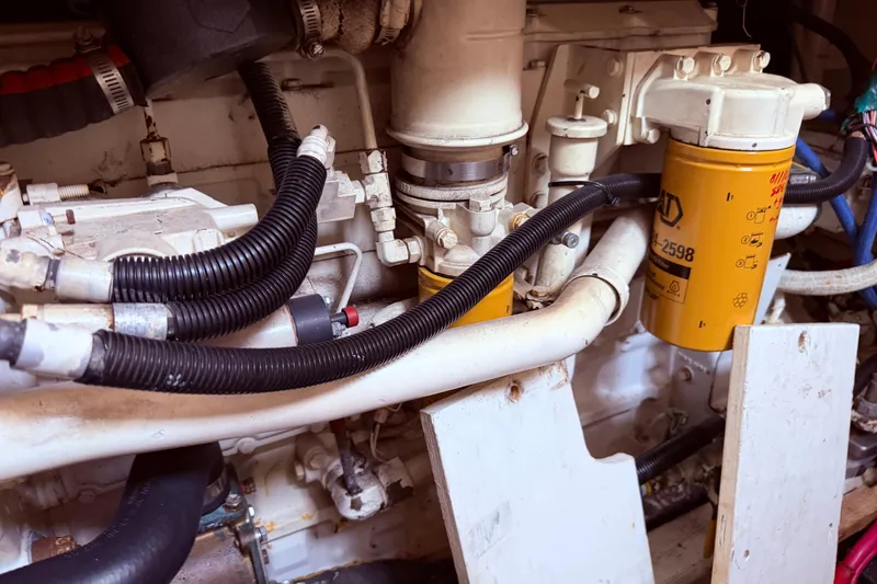 Slide: The Image of Engine compartment of a 1998 Sabreline 36 Fast Trawler with visible filters and hoses. - 39