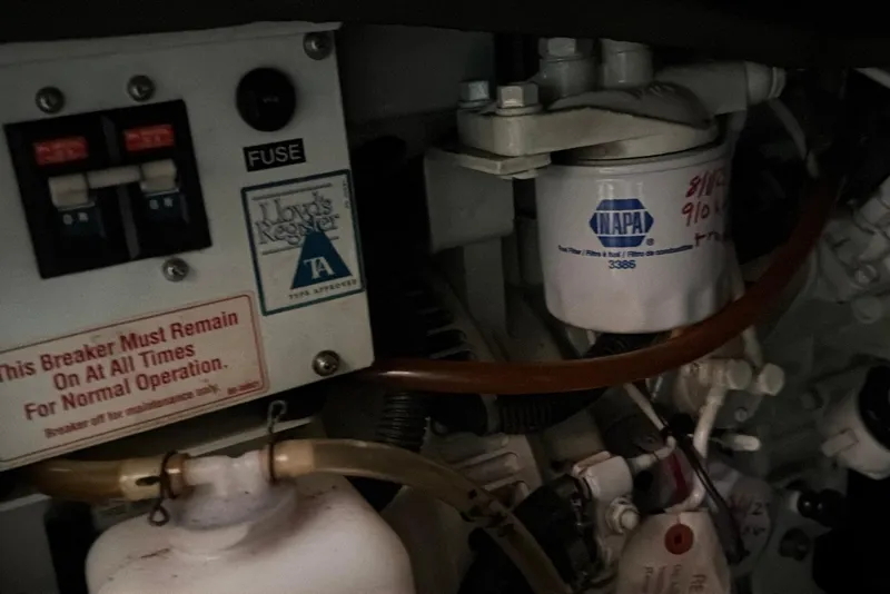Slide: The Image of Engine compartment of a 1998 Sabreline 36 Fast Trawler with fuse box and NAPA filter. - 41