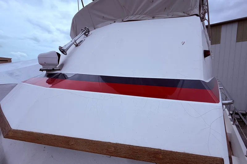 Slide: The Image of 1998 Sabreline 36 Fast Trawler with red and black stripe detail on deck. - 16