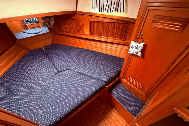Slide: The Image of Cozy cabin interior of 1998 Sabreline 36 Fast Trawler with blue cushions and wooden finish. - 33