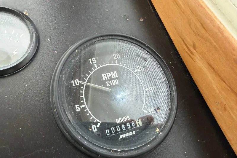 Slide: The Image of RPM gauge on 1998 Sabreline 36 Fast Trawler dashboard, showing 896 hours. - 26