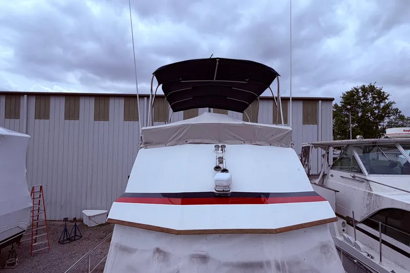 Slide: The Image of 1998 Sabreline 36 Fast Trawler docked, covered, with overcast sky background. - 15