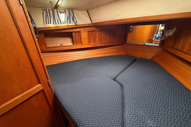 Slide: The Image of 1998 Sabreline 36 Fast Trawler cabin with cozy bed and wooden interior. - 34