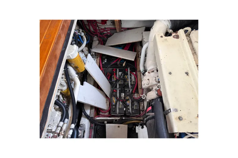 Slide: The Image of Engine compartment of a 1998 Sabreline 36 Fast Trawler with visible batteries and wiring. - 37