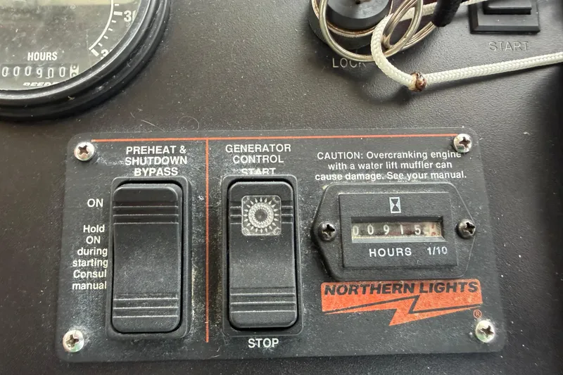 Slide: The Image of Control panel of a 1998 Sabreline 36 Fast Trawler with generator hour meter. - 44