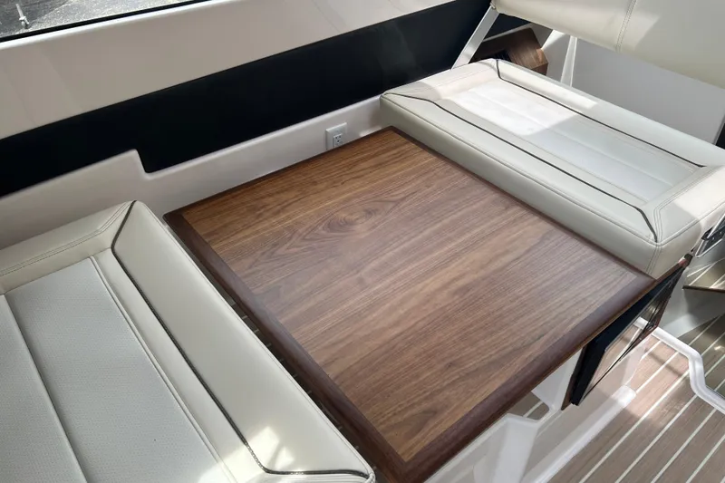 Slide: The Image of Luxurious interior of 2027 Solara S-250 Coupe with elegant wood table and leather seating. - 17