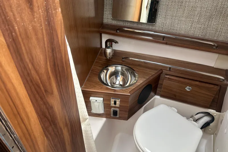 Slide: The Image of Compact bathroom in 2027 Solara S-250 Coupe with wood accents and stainless steel sink. - 27