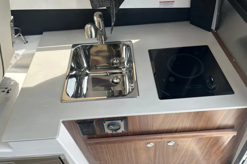 Slide: The Image of Compact kitchen area in 2027 Solara S-250 Coupe with sink and induction cooktop. - 18
