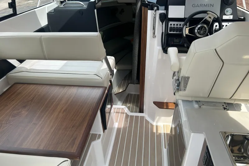 Slide: The Image of Interior of 2027 Solara S-250 Coupe boat with modern helm and seating area. - 12