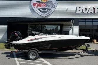Slide: The Image of 2024 Tahoe T18 boat on trailer outside dealership. - 10