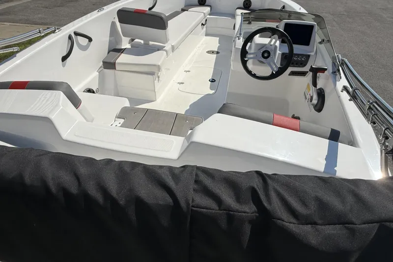 Slide: The Image of 2024 Tahoe T18 boat interior with steering wheel, seating, and dashboard. - 6