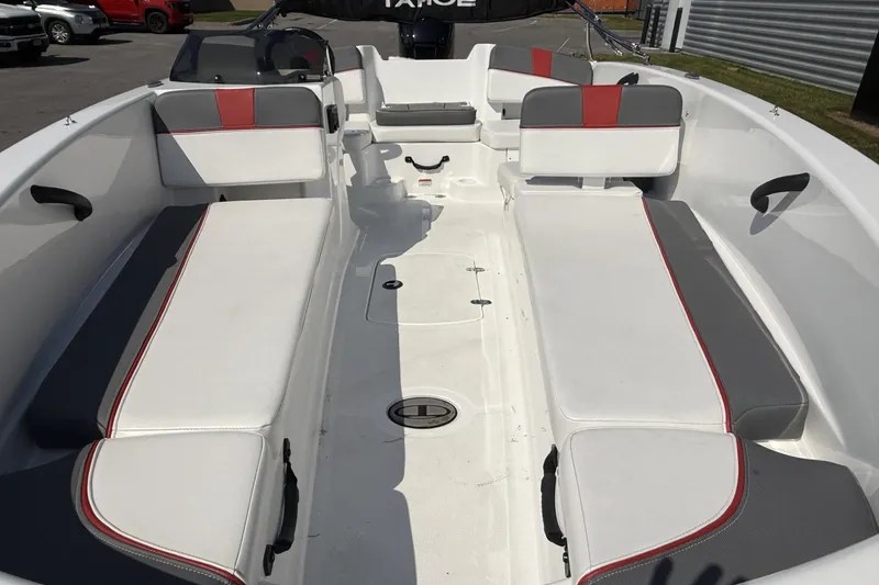 Slide: The Image of 2024 Tahoe T18 boat interior with white and gray seating, red accents. - 5