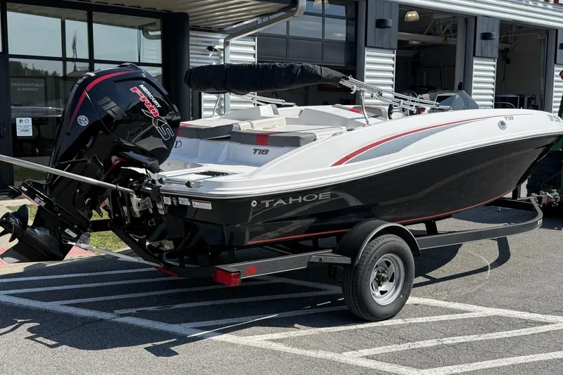 Slide: The Image of 2024 Tahoe T18 boat on trailer with Mercury engine, parked outside dealership. - 4