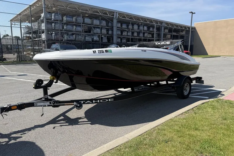 Slide: The Image of 2024 Tahoe T18 boat on trailer in parking lot, sunny day. - 2