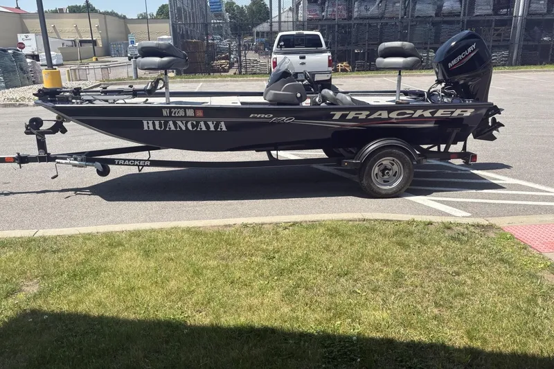 The Image of 2020 Tracker Pro 170 boat on trailer, parked outdoors, featuring Mercury engine. - 0