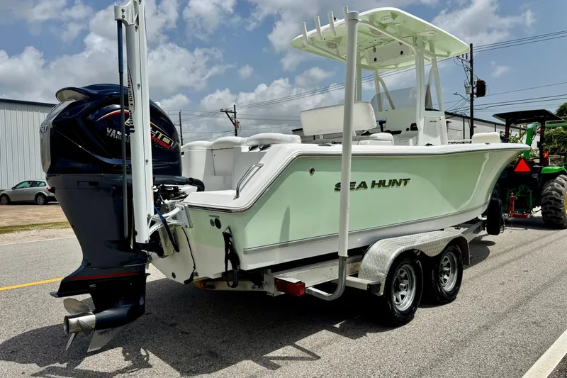 Slide: The Image of 2015 Sea Hunt Ultra 234 boat on trailer with Yamaha engine, parked outdoors. - 4