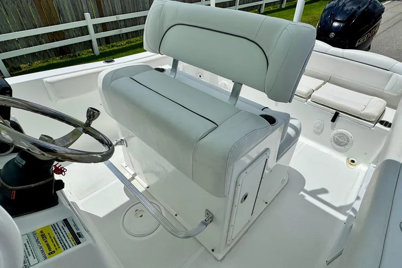 Slide: The Image of 2015 Sea Hunt Ultra 234 boat interior with white seating and steering wheel. - 9