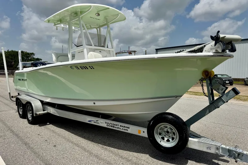 Slide: The Image of 2015 Sea Hunt Ultra 234 boat on trailer under cloudy sky. - 5