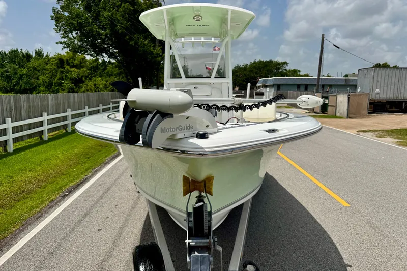 Slide: The Image of 2015 Sea Hunt Ultra 234 boat on trailer, featuring MotorGuide trolling motor. - 6