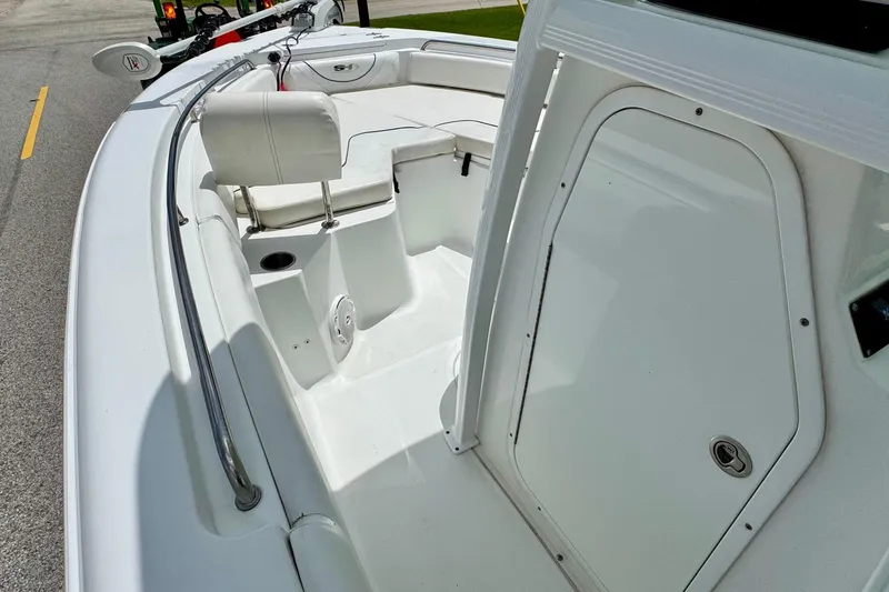 Slide: The Image of 2015 Sea Hunt Ultra 234 boat interior with seating and storage compartments. - 12