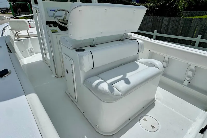 Slide: The Image of 2015 Sea Hunt Ultra 234 boat interior with white seating and steering console. - 8