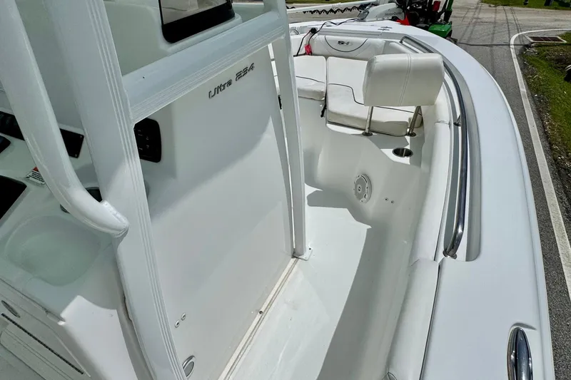 Slide: The Image of 2015 Sea Hunt Ultra 234 boat interior with seating and console view. - 15