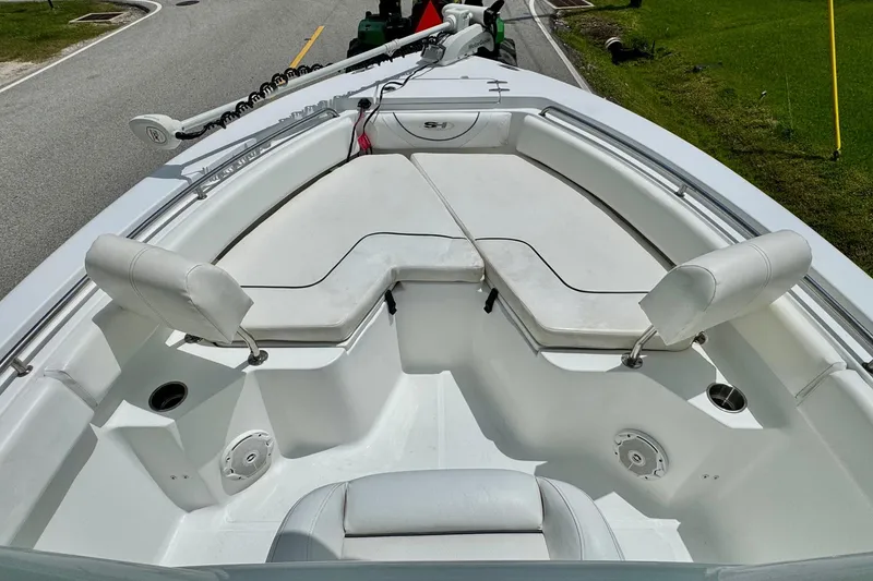 Slide: The Image of 2015 Sea Hunt Ultra 234 boat interior with cushioned seating and cup holders. - 14