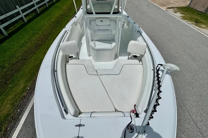 Slide: The Image of 2015 Sea Hunt Ultra 234 boat interior with seating and clean deck. - 16