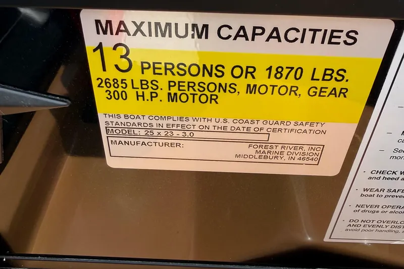 Slide: The Image of Maximum capacity label for 2026 Berkshire 23RFX STS boat, 13 persons or 1870 lbs. - 18