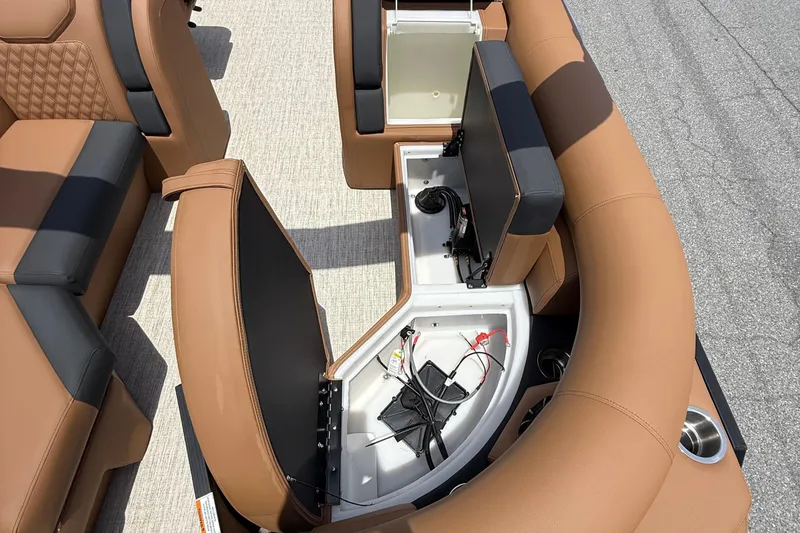 Slide: The Image of 2026 Berkshire 23RFX STS boat interior with open storage compartments and tan seating. - 15