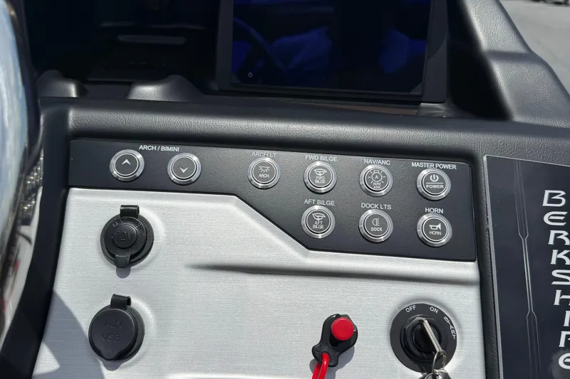Slide: The Image of Control panel of 2026 Berkshire 23RFX STS boat with various function buttons. - 14