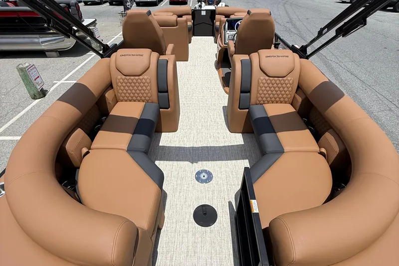 Slide: The Image of Luxurious interior of 2026 Berkshire 23RFX STS pontoon boat with tan and black seating. - 10