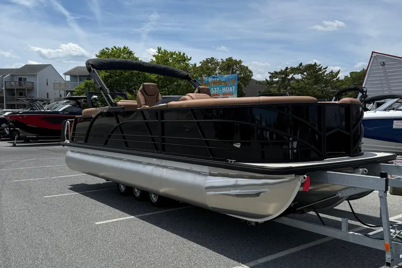 Slide: The Image of 2026 Berkshire 23RFX STS pontoon boat on trailer in parking lot, sunny day. - 1