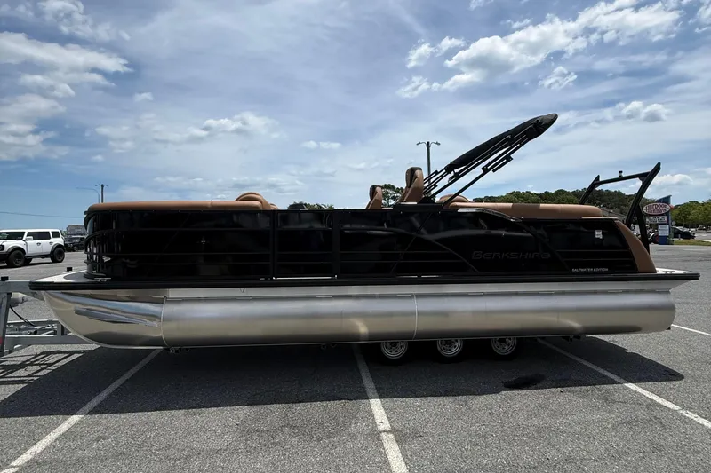 Slide: The Image of 2026 Berkshire 23RFX STS pontoon boat parked in a lot under a cloudy sky. - 4