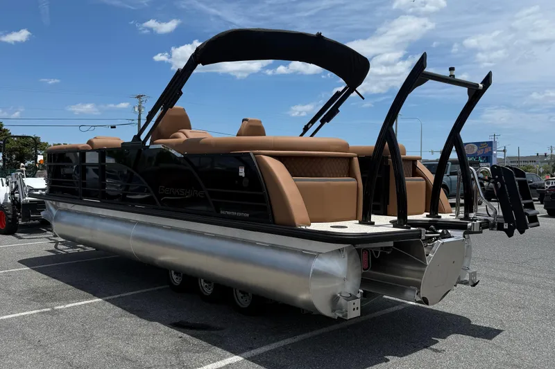 Slide: The Image of 2026 Berkshire 23RFX STS pontoon boat with sleek design and luxurious seating, parked outdoors. - 5