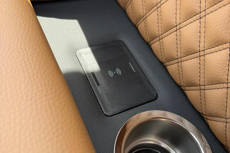 Slide: The Image of 2026 Berkshire 23RFX STS interior with wireless charging pad and cup holder. - 16