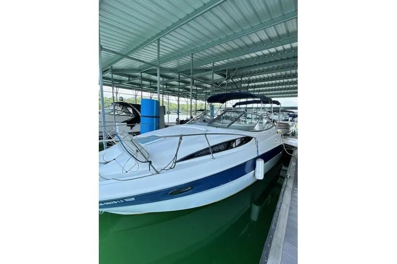 The Image of 2003 Bayliner 2655 Ciera boat docked under a covered marina. - 1