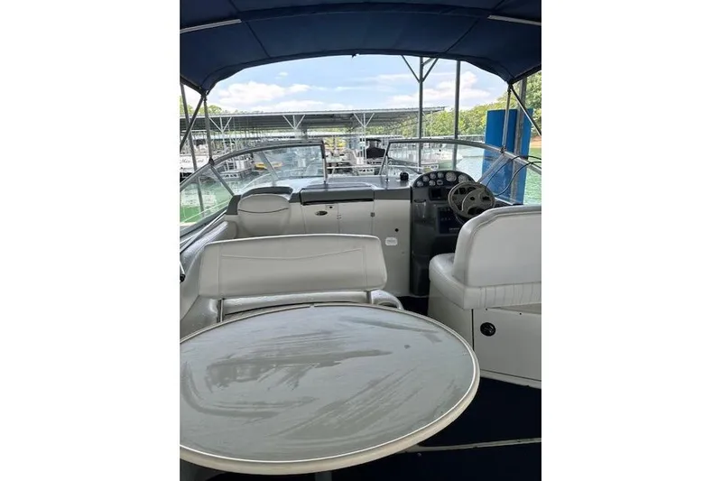 Slide: The Image of 2003 Bayliner 2655 Ciera boat interior with seating and helm, docked at marina. - 4