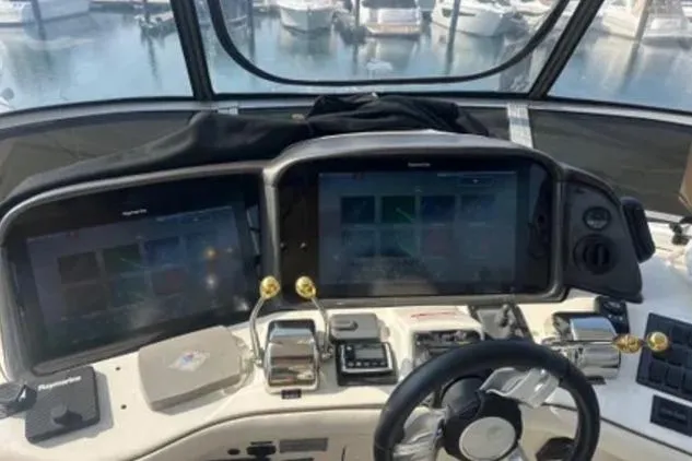 Slide: The Image of Helm of 2007 Sea Ray 44 Sedan Bridge with dual navigation screens and controls. - 17