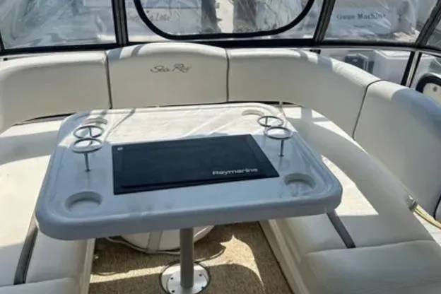 Slide: The Image of 2007 Sea Ray 44 Sedan Bridge interior with seating and table setup. - 21